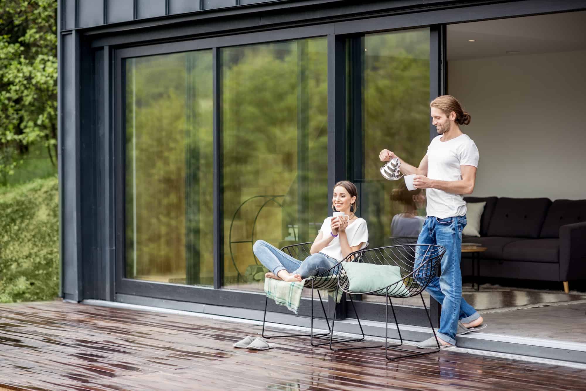Couple standing on the terrace of a modern house